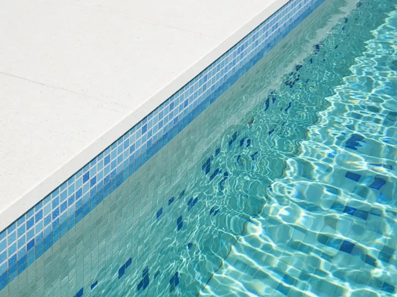 Clean pool edge with blue mosaic tiles